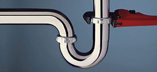 plumbing wrench attached to a drain pipe